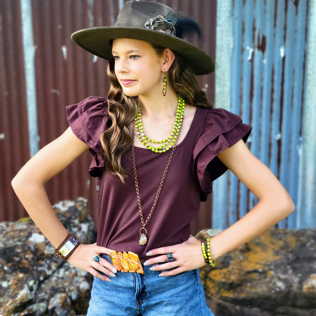 Womens belt with orange Regalite inlay buckle, styled with necklace and bracelets