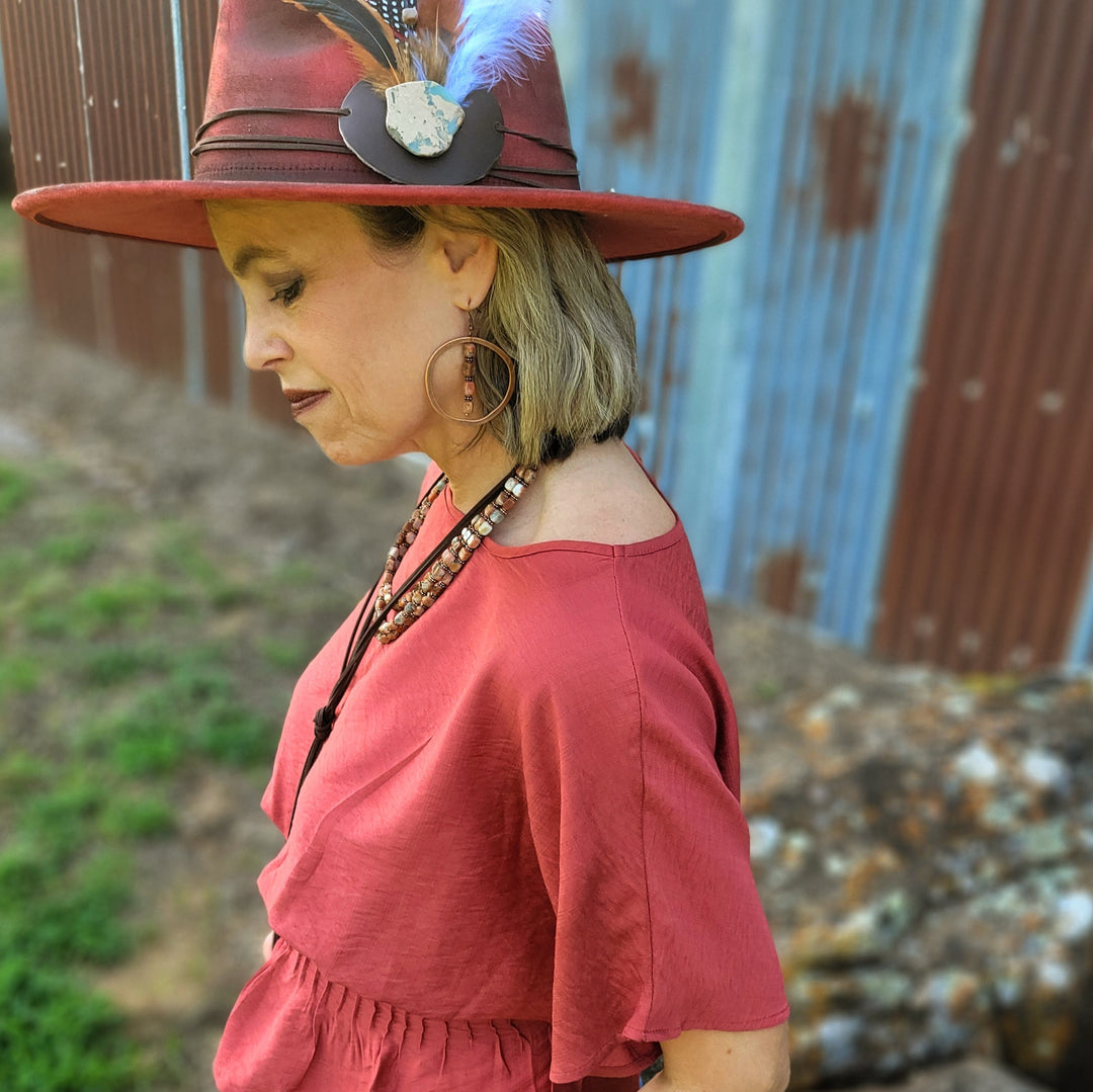 Copper hoop earrings with bead-stacked dangles on model