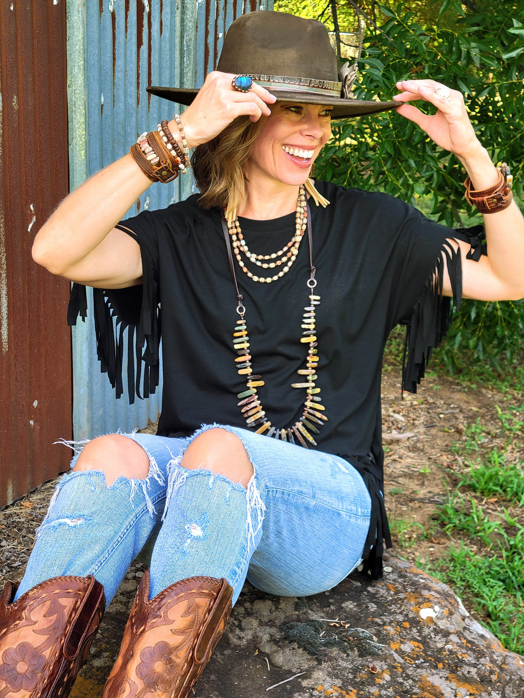 Olive felt cowgirl hat with dark band, wide brim and distressed paint
