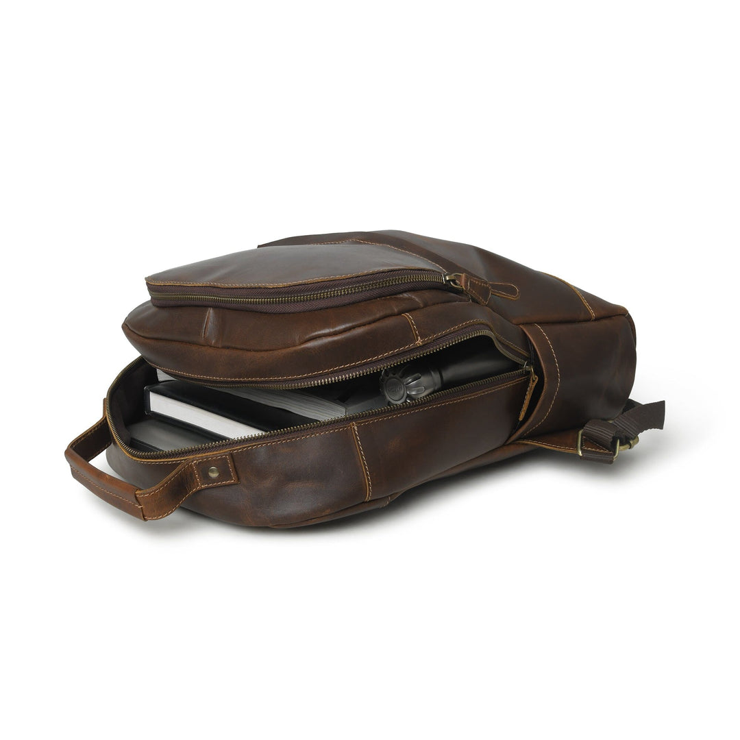 Brown buffalo leather backpack side view with top zipper and leather shoulder strap.