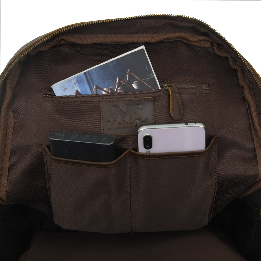 Brown leather backpack interior view with organizer pockets and zippered main compartment.