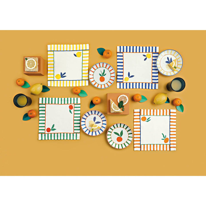 Mini citrus decorative plates arranged on a play table with striped and fruit patterns