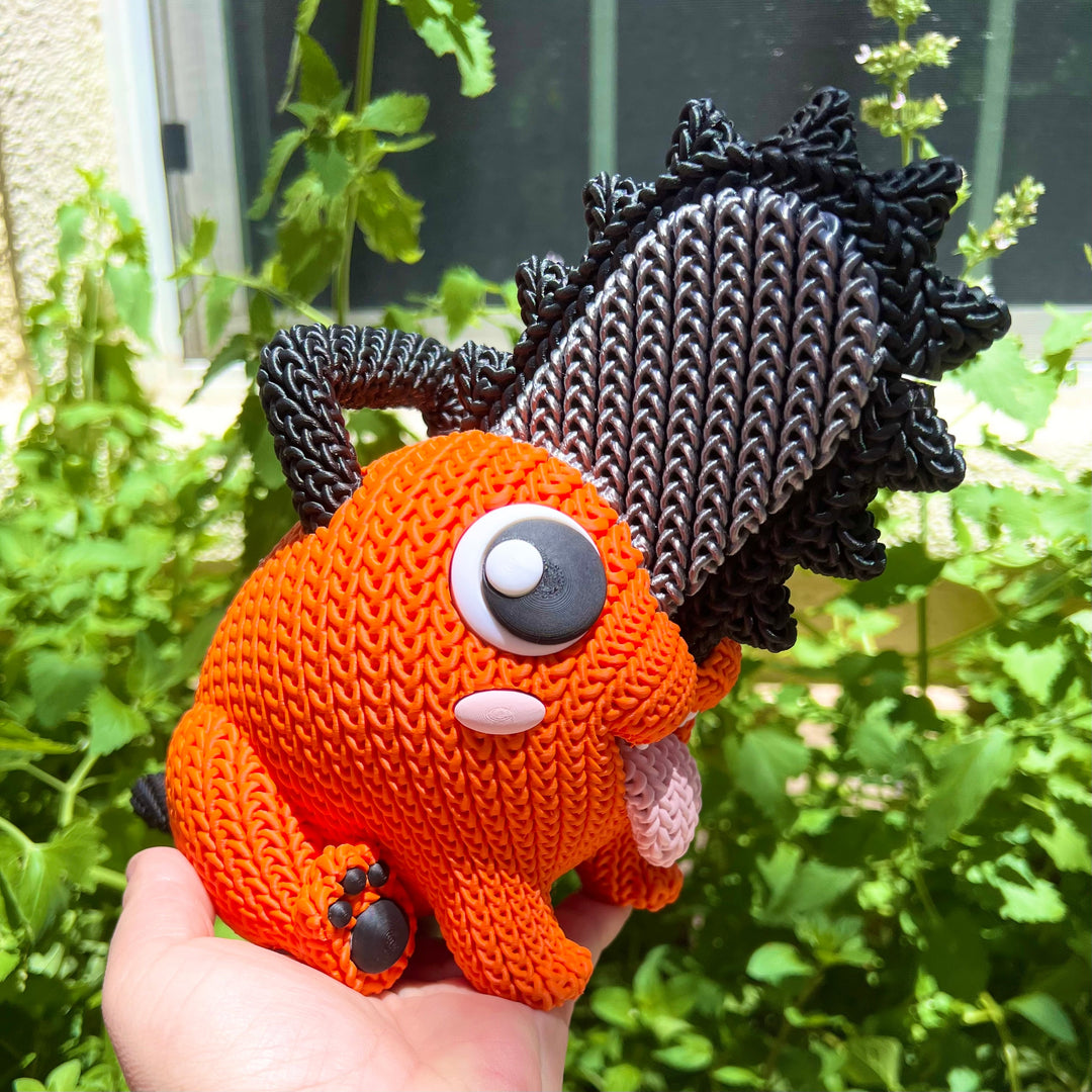 Orange knit plush with black mane, gray button eye, white nose patch, front legs