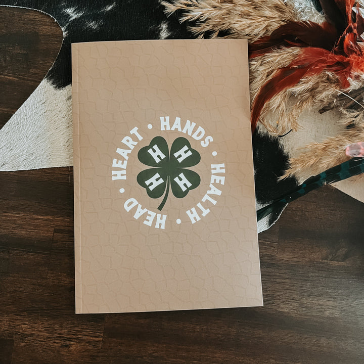 Beige textured pocket journal cover with 'HEARTH & HANDS' clover emblem