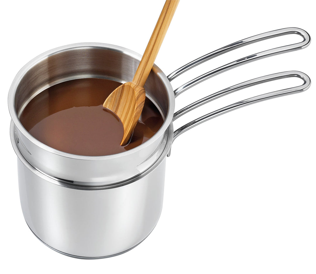 Stainless-steel double boiler saucepan with interior pour and wooden stirring utensil