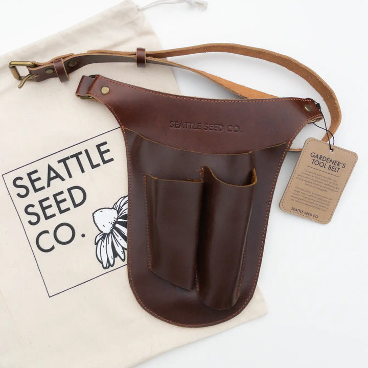 Genuine leather tool belt laid flat with front pockets and hanging tag