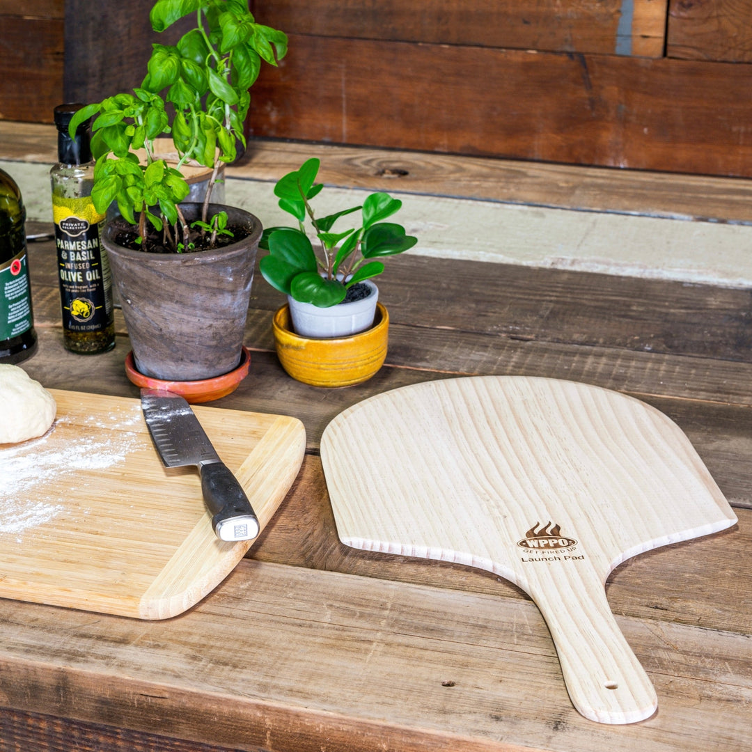 Set of wooden pizza peels with arched paddles and handles, light wood grain