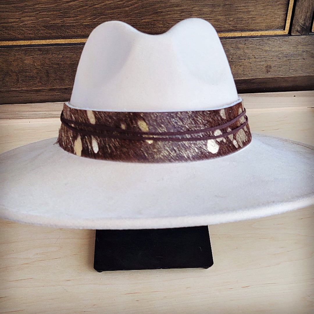 White wide-brim felt hat with dark-brown metallic patterned band and centered crown