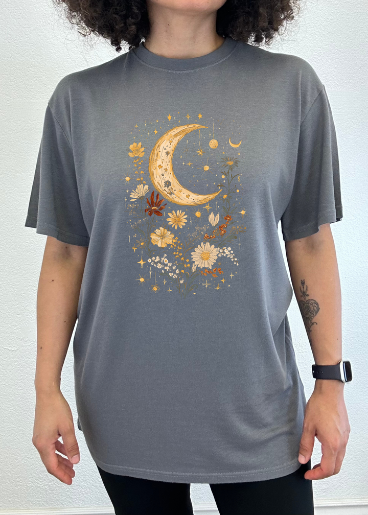 Unisex graphic T-shirt in charcoal gray with gold crescent moon and flower artwork.