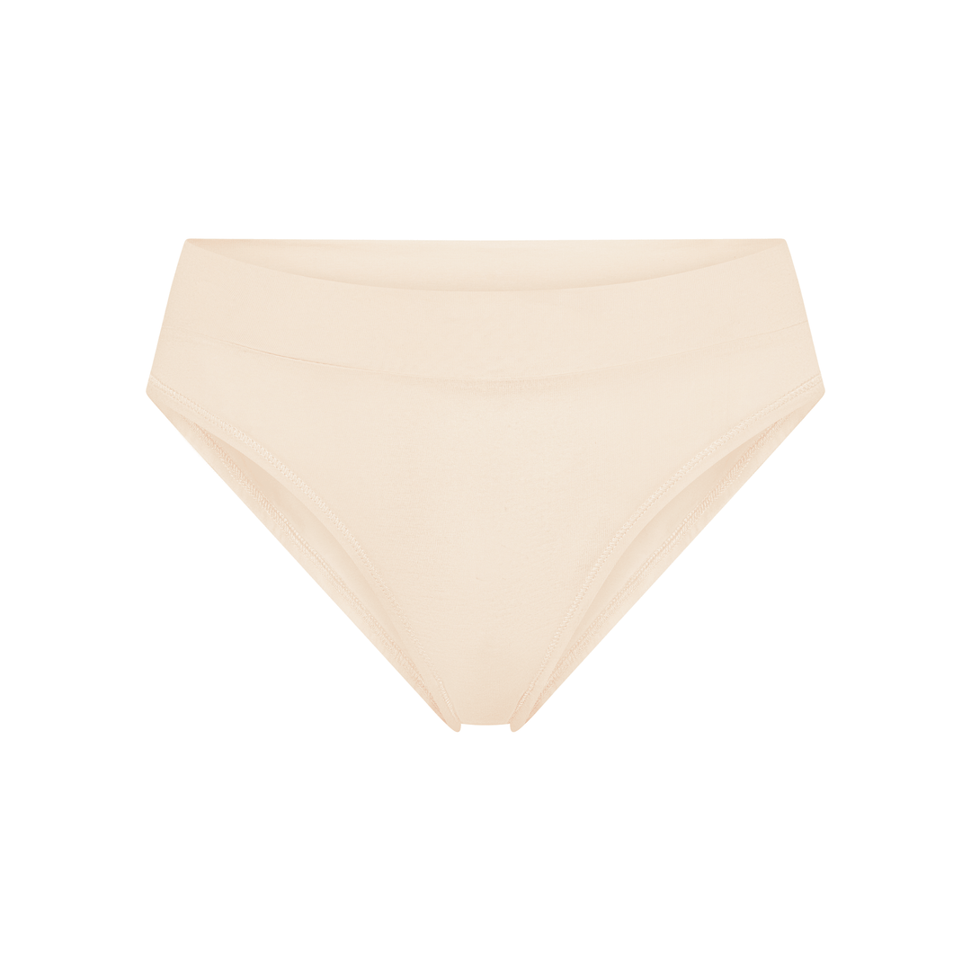 Nude/latte cheeky tanga briefs, low-rise with triangular front and minimal coverage.