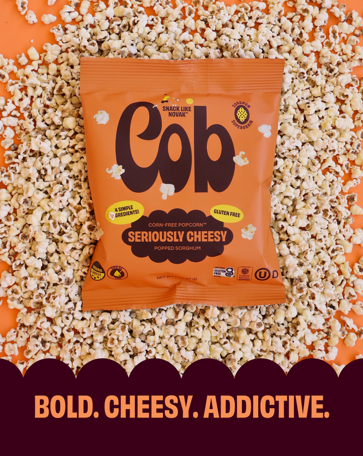 Seriously Cheesy corn-free popcorn snack bag on a bed of popped popcorn