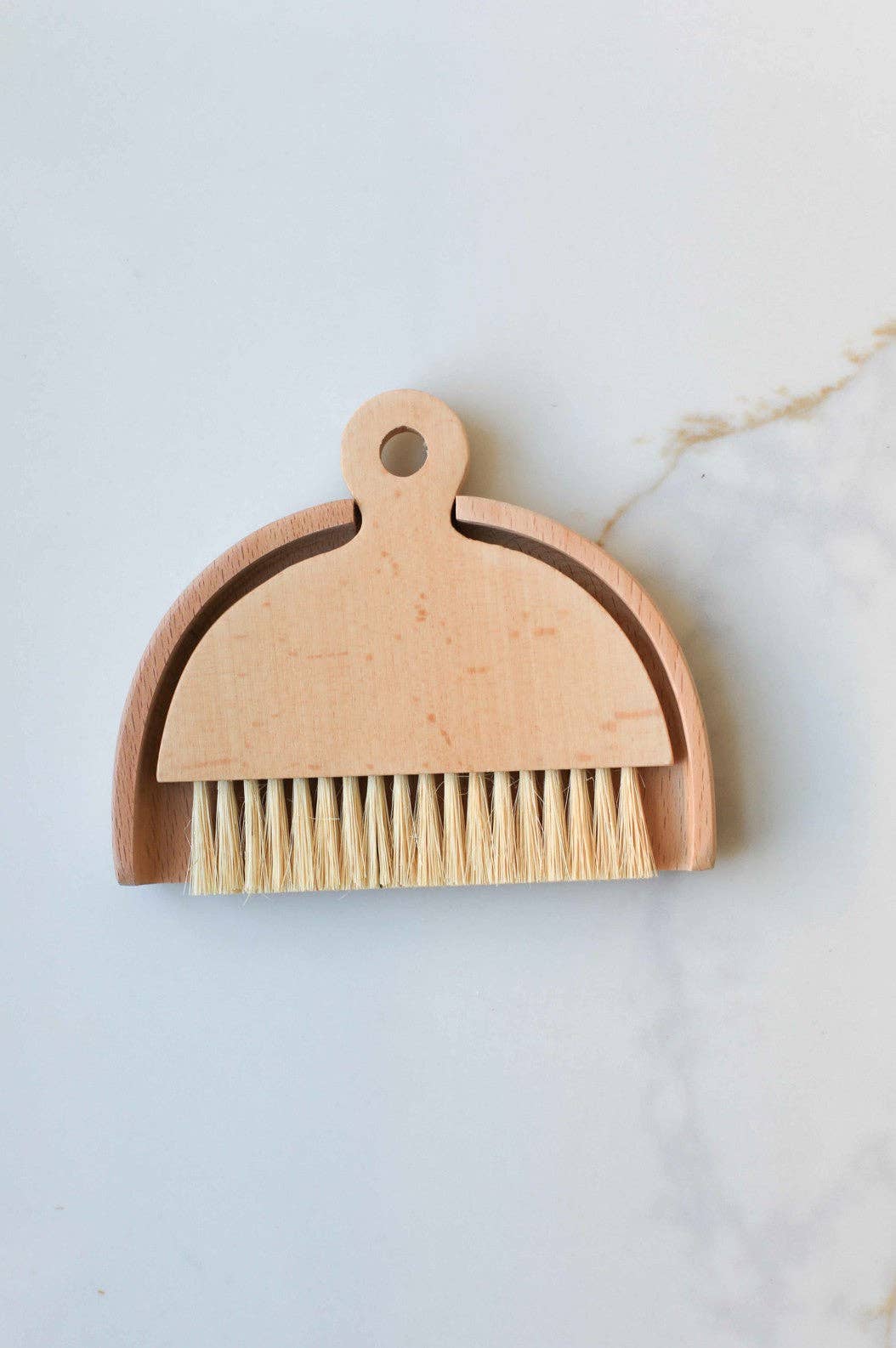 Wood table brush with loop handle and tan bristle head, light wood finish