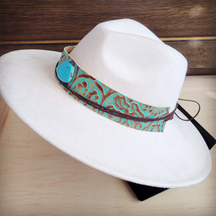 White felt cowboy hat with turquoise patterned wide leather band along the brim