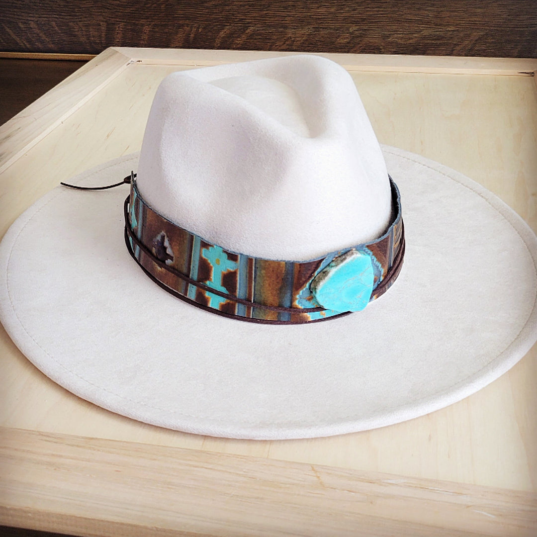 White felt wide-brim hat with brown-and-blue patterned leather band and turquoise accent