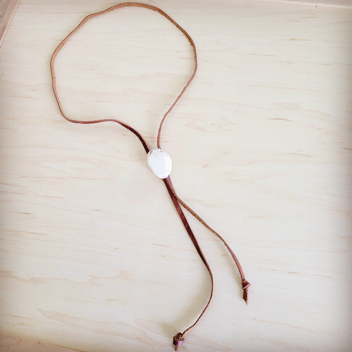 Leather lariat necklace featuring a white oval turquoise slab pendant with two ties