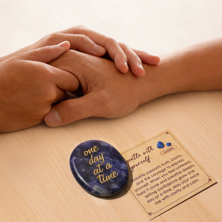 Blue oval pocket crystal stone with gold “one day at a time” text