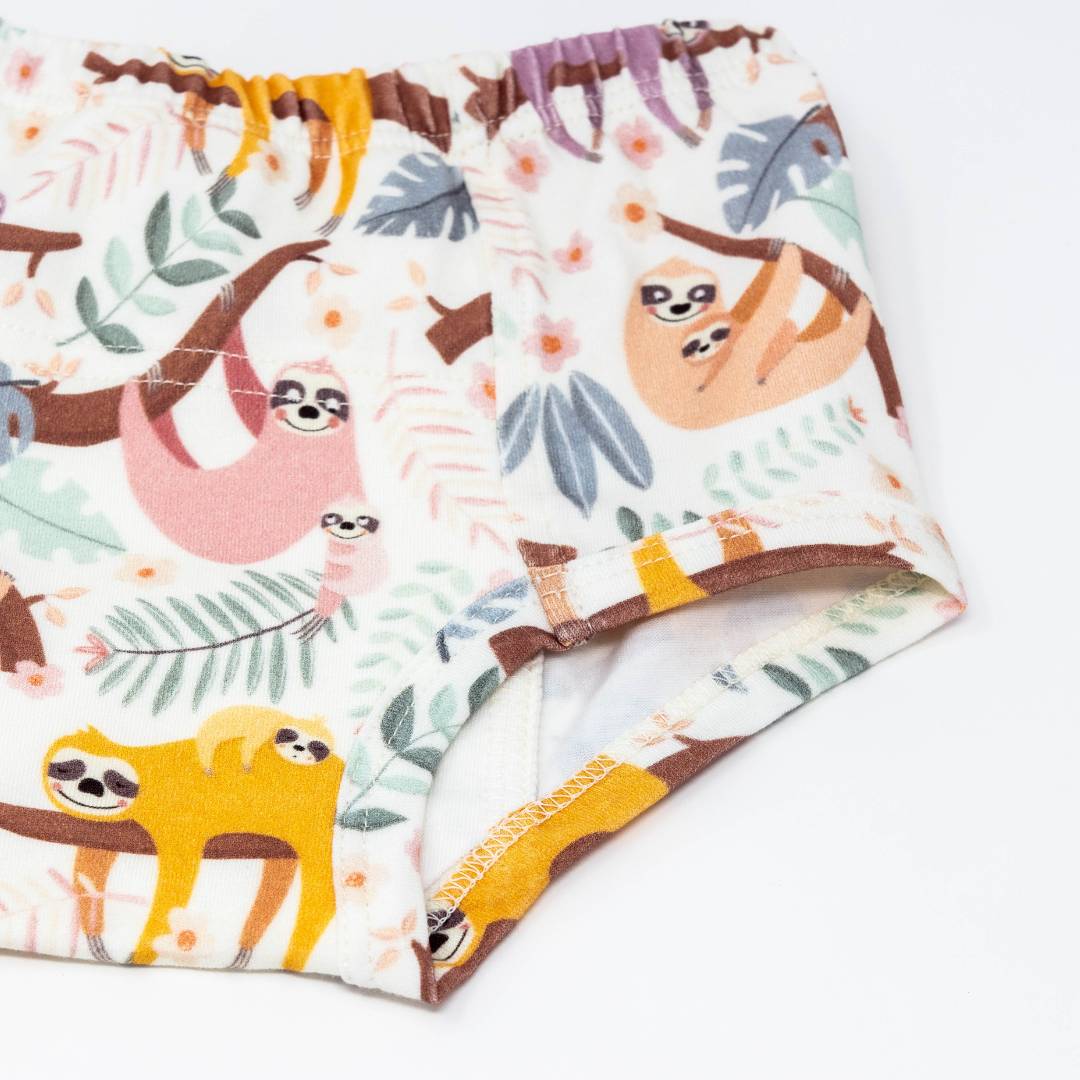 Close-up of cream training underpants with sloth print and yellow trim elastic leg openings