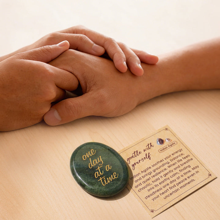 Green oval pocket crystal stone with gold “one day at a time” text