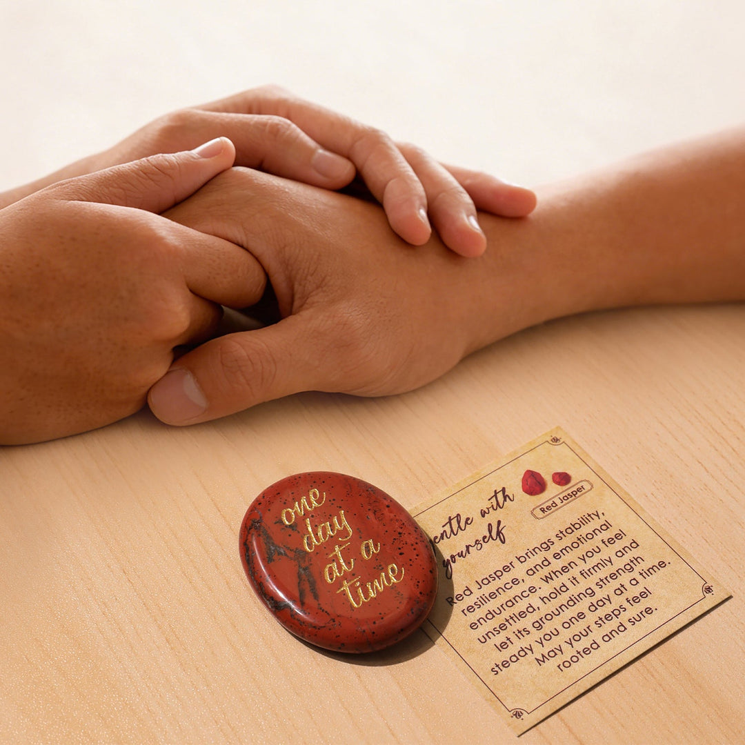 Red oval pocket crystal stone with gold “one day at a time” text