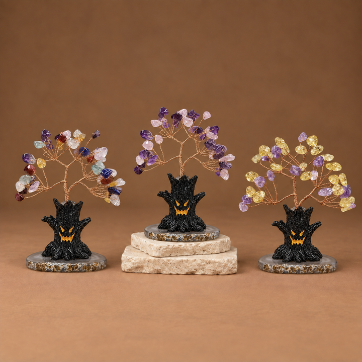 Halloween crystal tree sculpture with purple and gold gemstone branches on black base