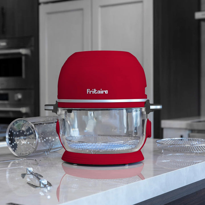 Cherry red countertop air fryer with open clear glass bowl on kitchen counter