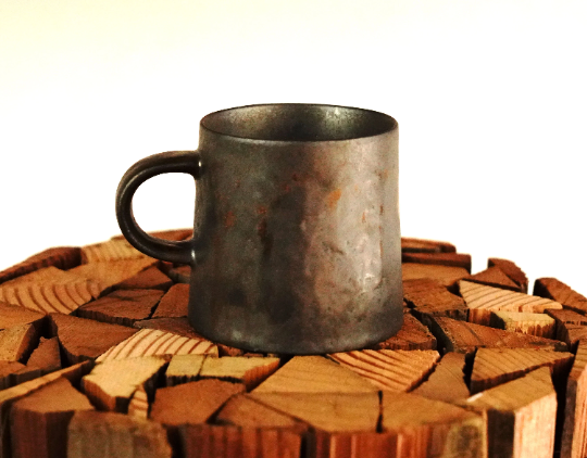 Stone-gray and bronze espresso mug side view, dark handle and speckled finish