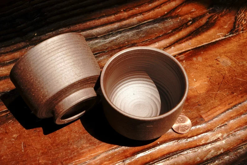 Small rough Arabic-style tea cup set, ribbed ceramic cups with circular base on wood