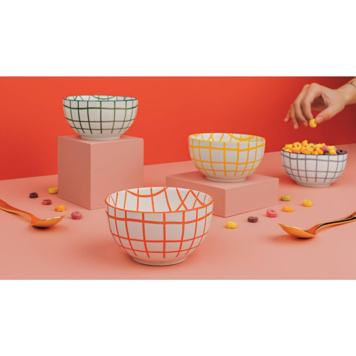 Check bowls in green, yellow, orange, and a small blue bowl on display