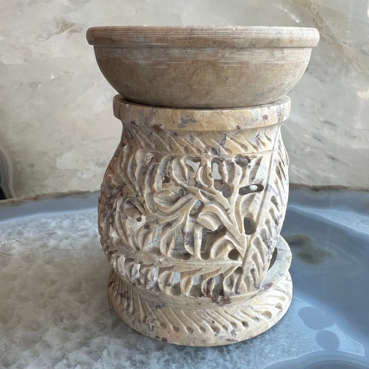 Carved soapstone essential oil burner with ornate leaf scroll carving and circular opening