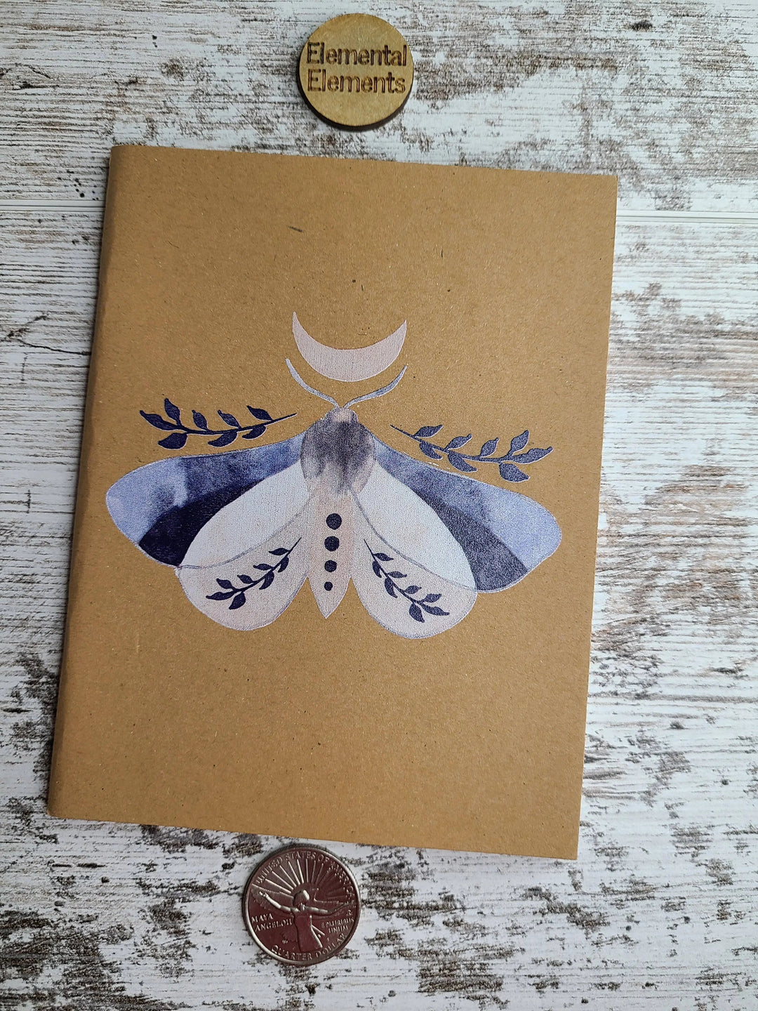 Brown journal with watercolor moon moth illustration on the front cover