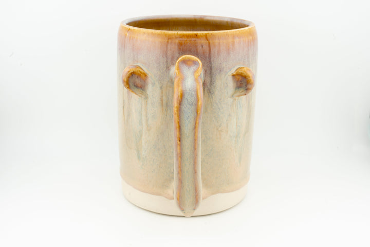Ceramic stein mug with central drip detail, light cream body, caramel-brown rim