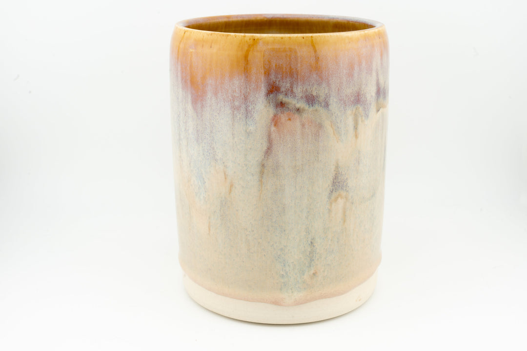 Ceramic stein mug with light cream body and caramel-brown drip accents