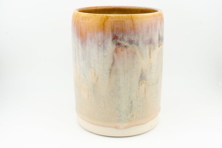 Ceramic stein mug with light cream body and caramel-brown drip accents