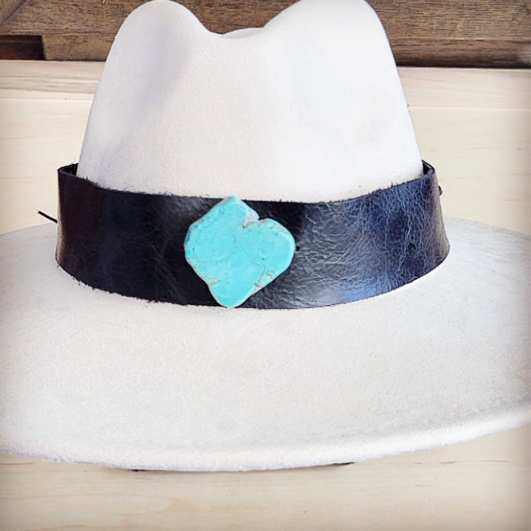 Wide-brim white felt hat featuring dark leather band with turquoise heart detail
