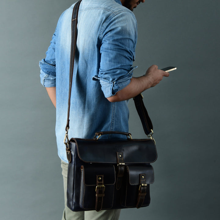Dark blue laptop messenger bag with front flap pockets and adjustable shoulder strap