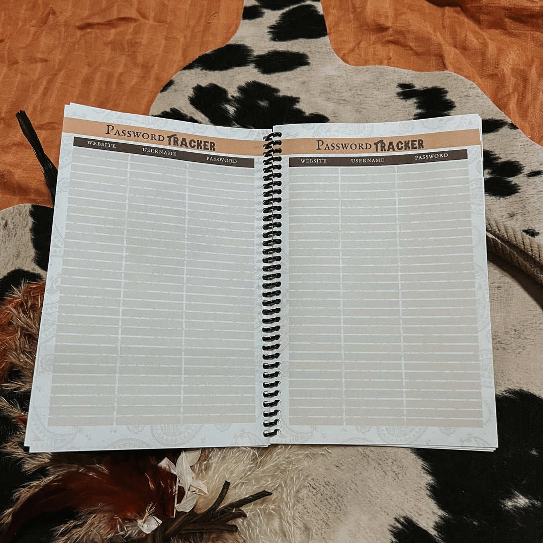 Open password tracker notebook with “Password Tracker” title and lined grid pages