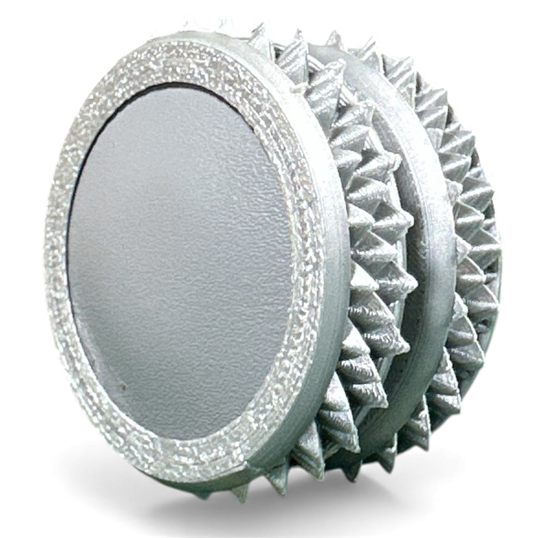 Silver gray fidget moon toy with light gray oval center and spiky ridged edges