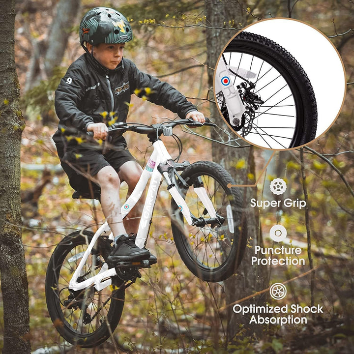 Kids 20-inch mountain bike riding view with knobby tires and front suspension fork