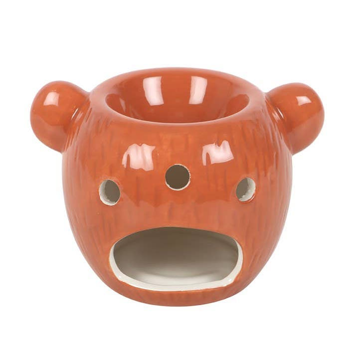 Orange bear oil burner with front burner opening, rounded ears, and button eyes