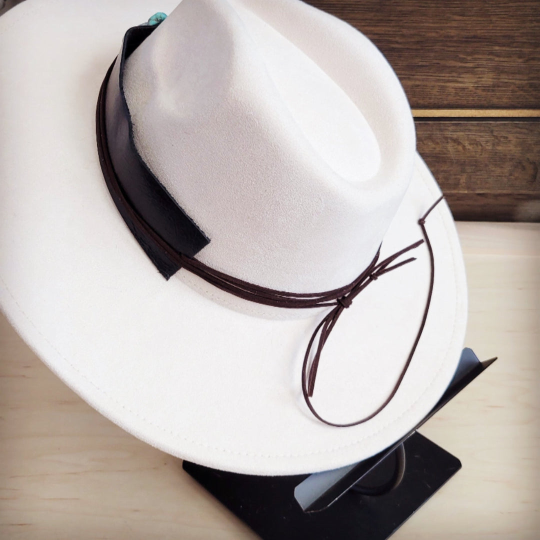 White felt wide-brim hat with dark leather band and turquoise heart accent; tie string
