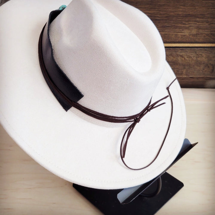 White felt wide-brim hat with dark leather band and turquoise heart accent; tie string