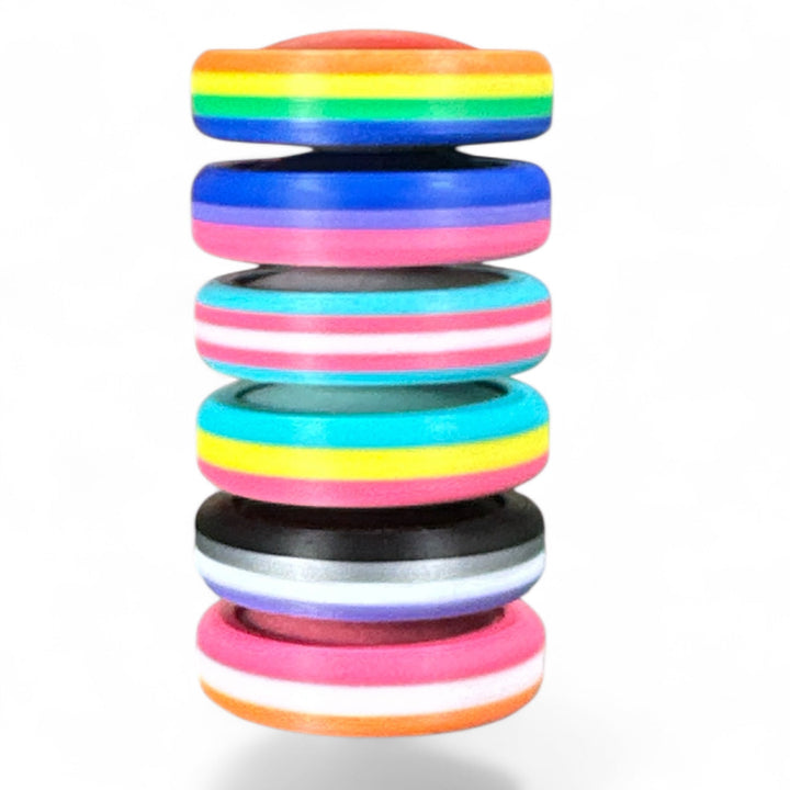 Stack of pride rainbow striped round bands with orange, rainbow, pink, and gray stripes