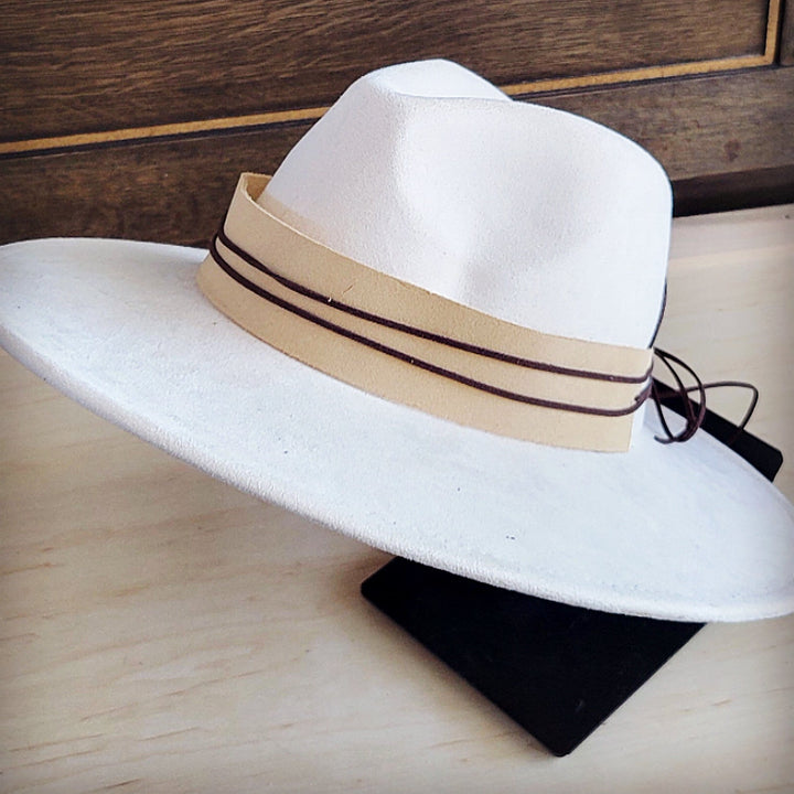 Wide-brim felt hat with tan suede band, dark trim, and lace ties