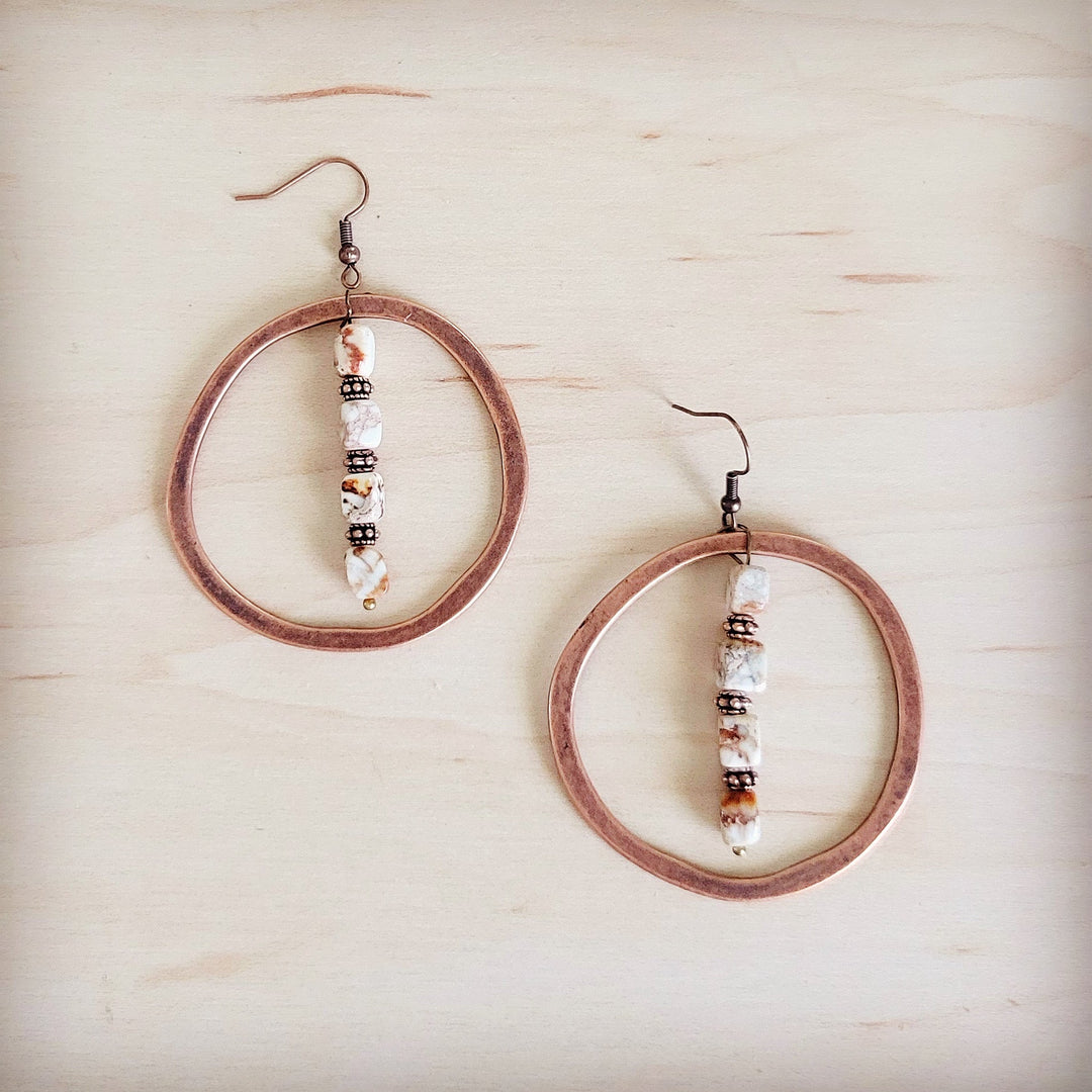 Copper hoop earrings with stacked white, brown, and black bead drop accents
