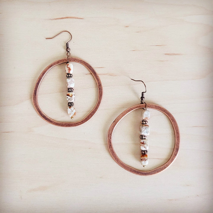 Copper hoop earrings with stacked white, brown, and black bead drop accents