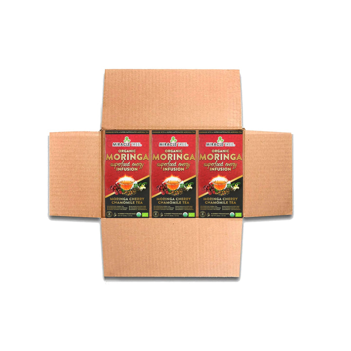 Cardboard shipping box containing multiple Miracle Tree organic moringa tea boxes