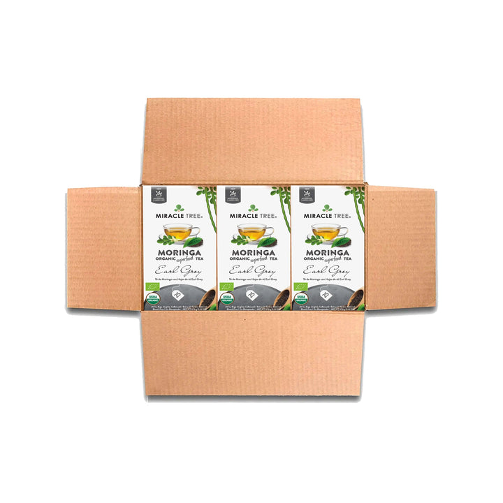 Tea box set with multiple organic moringa Earl Grey tea cartons in a cardboard carrier