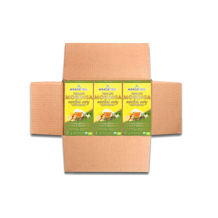 Cardboard tea box with three Miracle Tree organic moringa ginger & lemon tea bags