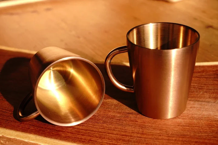 Copper double wall stainless steel mug pair, copper finish with one tilted