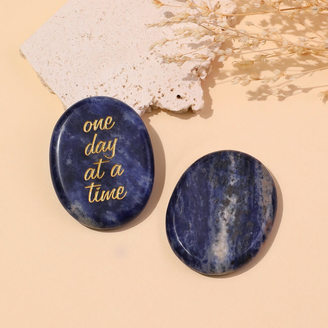 Dark blue round pocket crystal stone with gold “one day at a time” text
